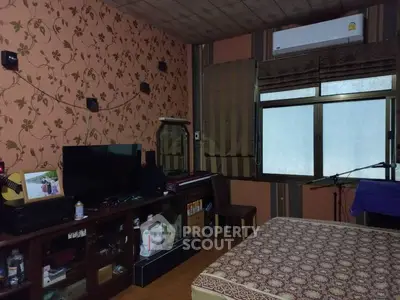 Cozy bedroom with floral wallpaper and air conditioning unit