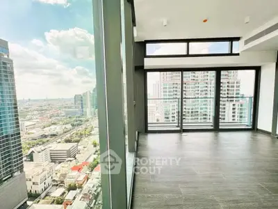 Spacious corner unit with floor-to-ceiling windows offering stunning city views in a modern high-rise building.