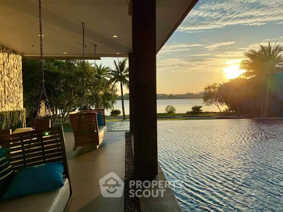 Luxurious poolside view with stunning sunset and palm trees, perfect for relaxation and leisure.