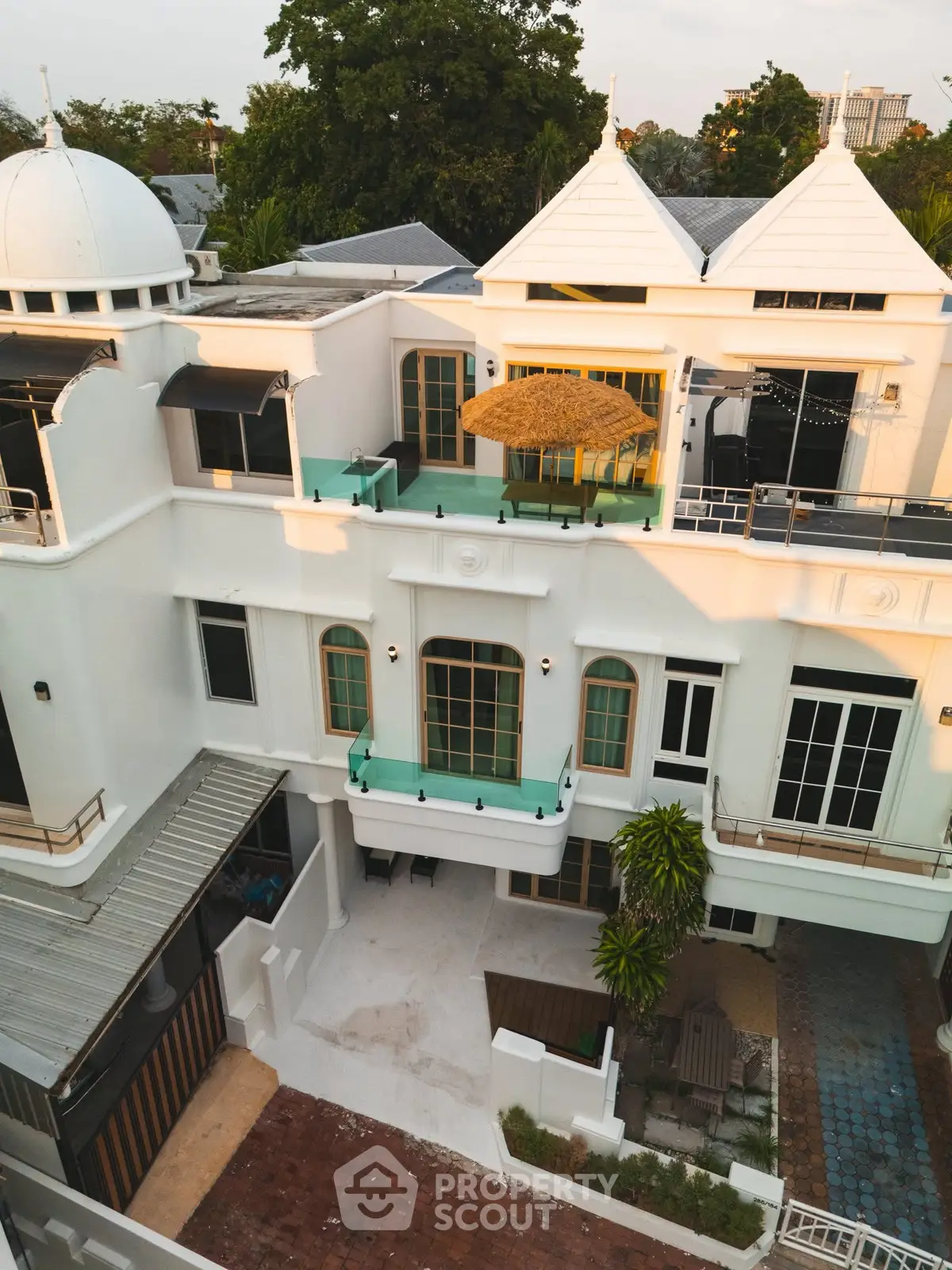 Stunning white villa with unique architecture and spacious balconies in a serene neighborhood.