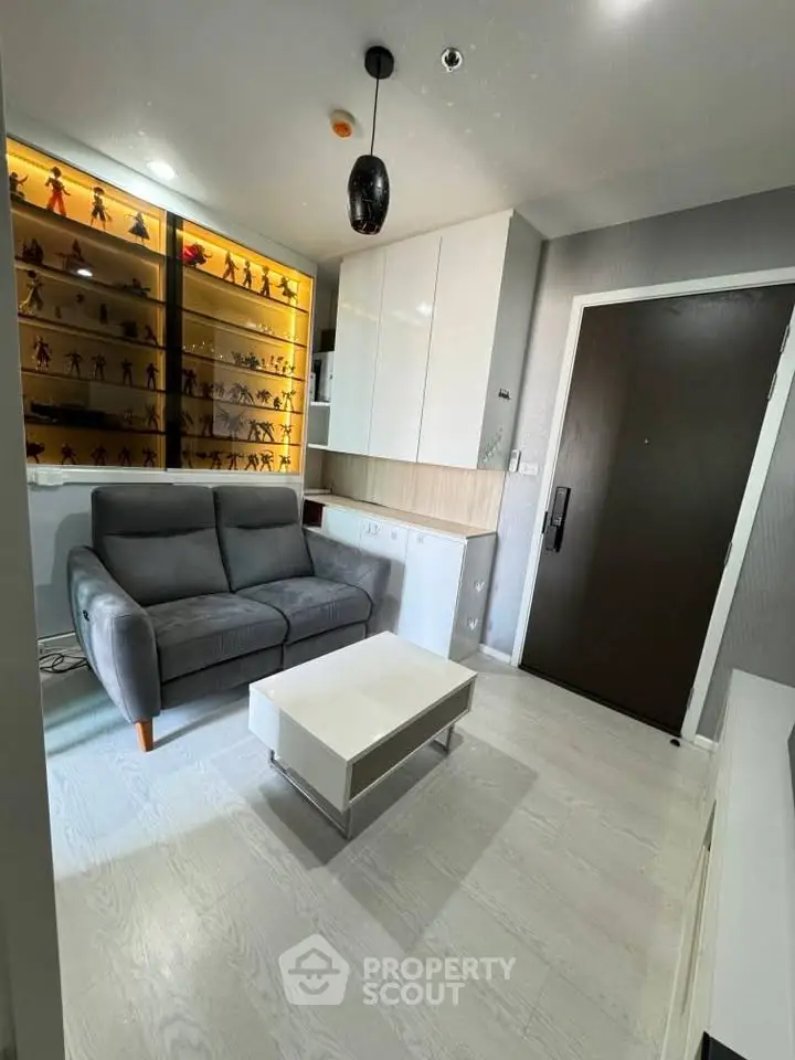 Modern living room with sleek furniture and display shelves, perfect for urban living.