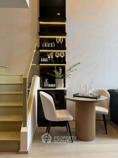 Stylish modern dining area with elegant staircase and built-in shelving