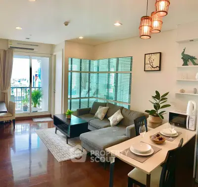 Spacious modern living room with elegant decor and open layout, featuring cozy seating and abundant natural light.
