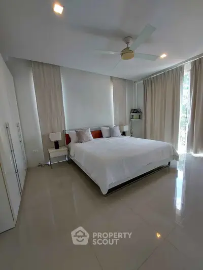 Spacious modern bedroom with elegant decor and natural light