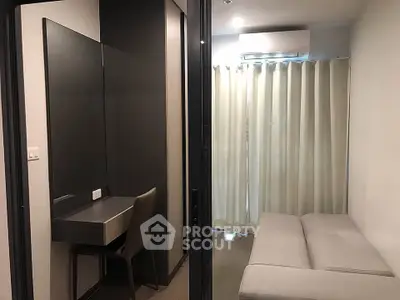 Modern apartment interior with cozy living area and study nook, featuring sleek furniture and natural light.