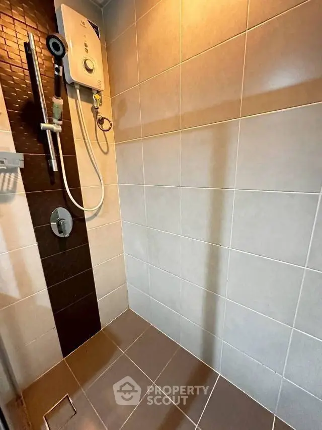 Modern bathroom with sleek shower and tiled walls, perfect for a contemporary home.