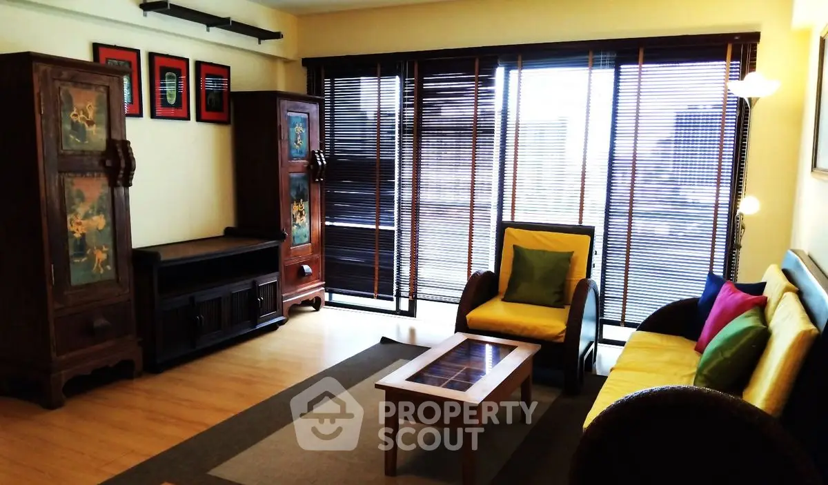 Stylish living room with vibrant decor and large windows for natural light.