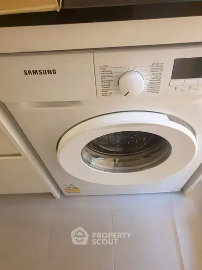 Modern Samsung washing machine in sleek laundry area
