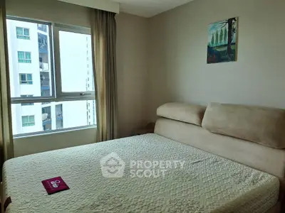 Cozy bedroom with large window and modern decor in urban apartment