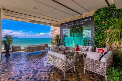 Luxurious balcony with stunning ocean view and stylish outdoor seating area.