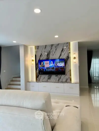 Luxurious modern living room with marble accent wall and built-in TV unit