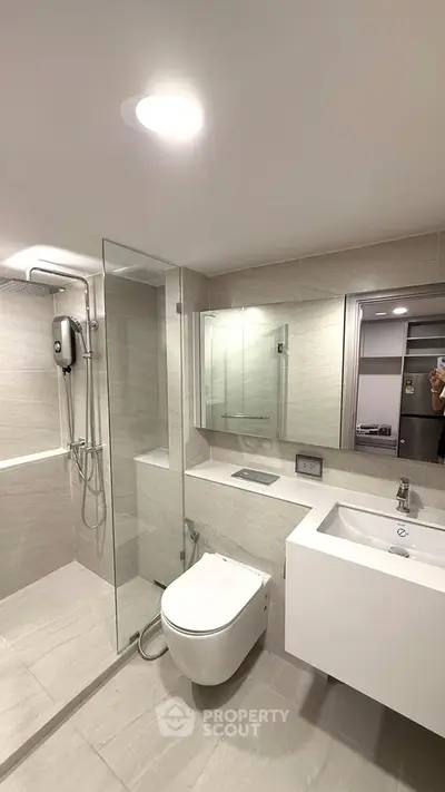 Modern bathroom with sleek fixtures and glass shower enclosure