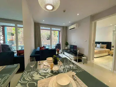 Modern open-plan living room with dining area and balcony view