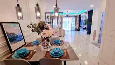 Luxurious open-plan living and dining area with elegant decor and modern lighting.