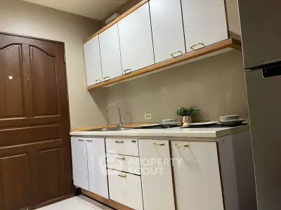 Charming kitchen with sleek cabinets and modern design, perfect for culinary enthusiasts.
