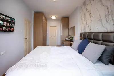 Spacious modern bedroom with elegant decor and ample storage space.