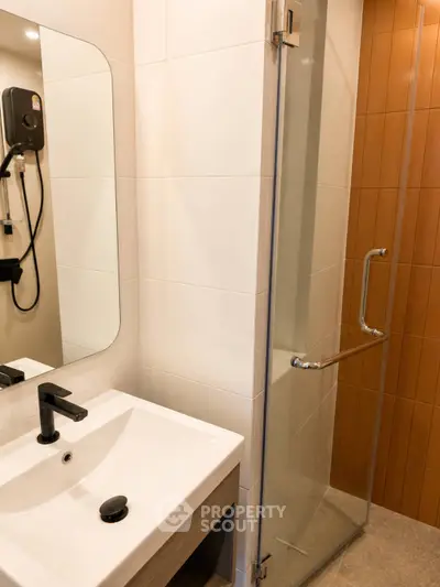 Modern bathroom with sleek sink and glass shower enclosure