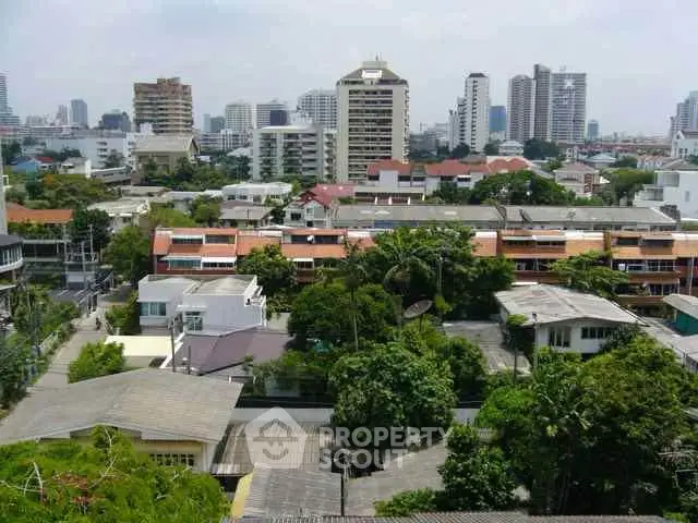 Stunning cityscape view showcasing urban residential and commercial buildings amidst lush greenery.