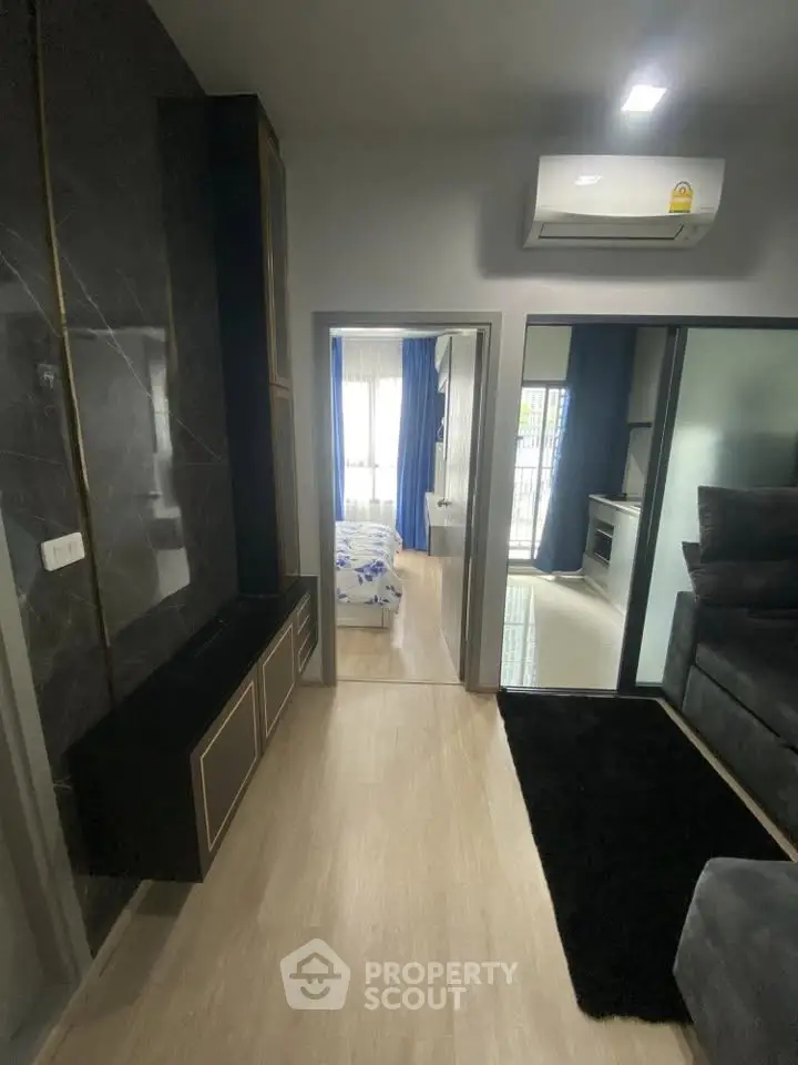 Modern apartment interior with sleek design and air conditioning, featuring a cozy bedroom and stylish living area.