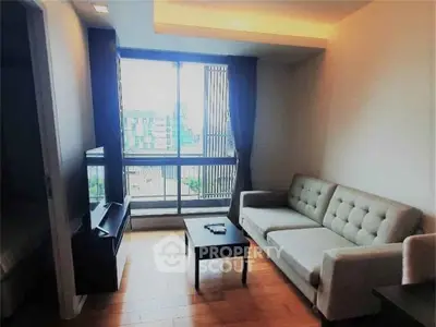 Modern living room with large window and stylish furniture