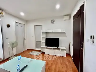 Modern living room with wooden flooring and sleek white furniture