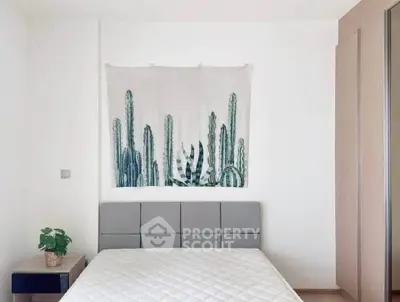 Minimalist bedroom with cactus wall art and modern furniture