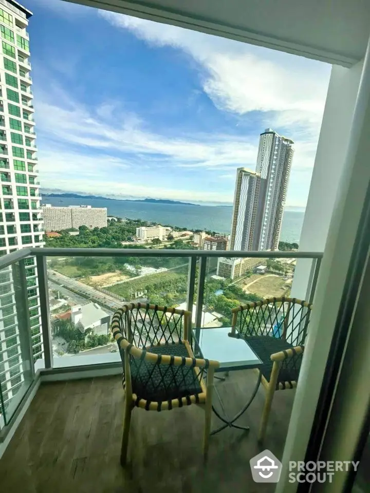 Stunning high-rise balcony with breathtaking ocean view and modern outdoor seating.