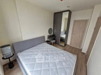 Modern bedroom with stylish furniture and large mirror wardrobe