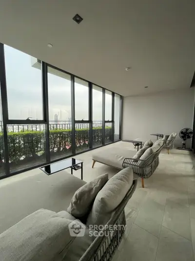 Spacious balcony with modern seating and panoramic city views, perfect for relaxation and entertaining.
