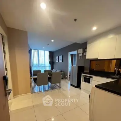 Modern open-layout kitchen and dining area with sleek design and ample natural light.