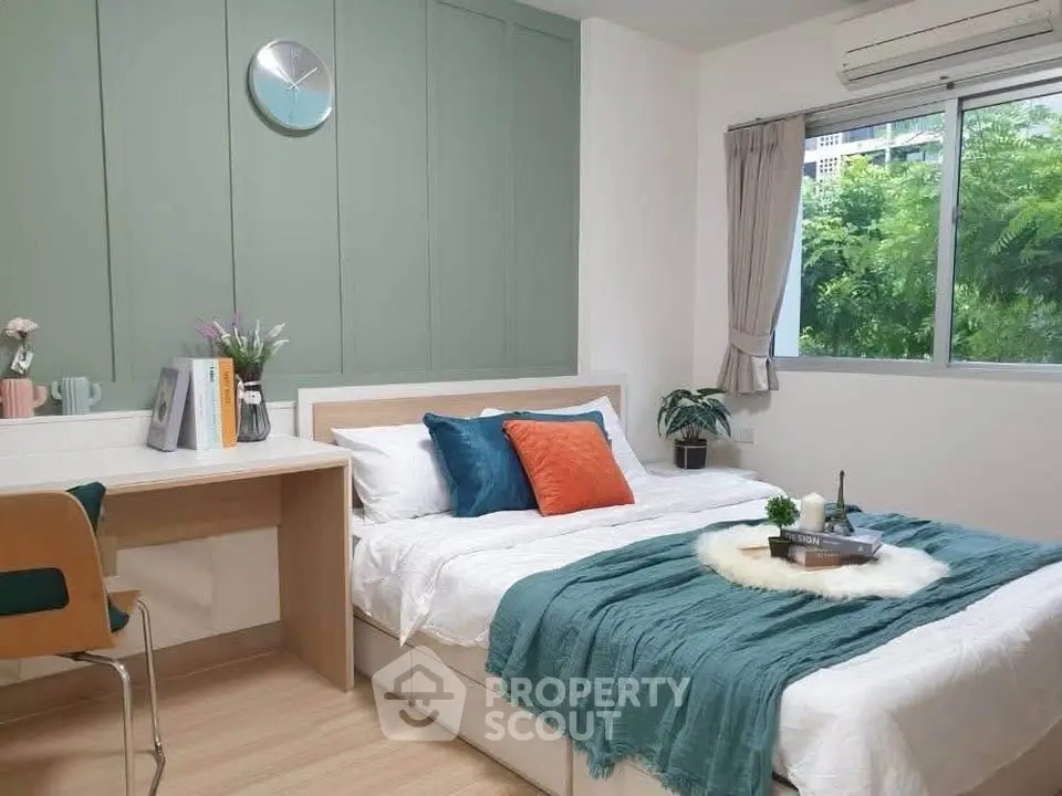 Cozy bedroom with modern decor, large window, and stylish desk area, perfect for relaxation and productivity.
