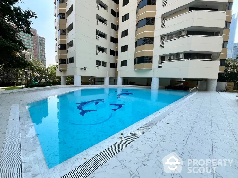 Luxurious apartment complex with a pristine swimming pool and modern architecture.