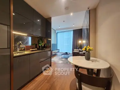 Modern open-layout kitchen and living room with sleek design and cozy ambiance.