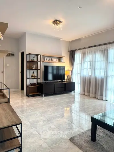 Spacious modern living room with large windows and elegant decor