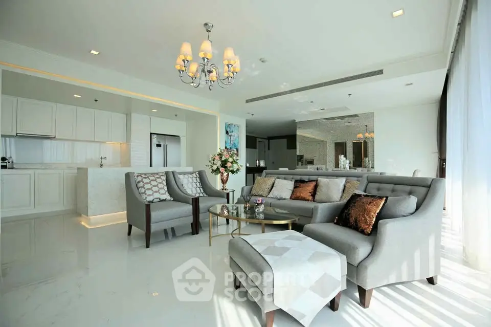 Luxurious open-plan living room with elegant decor and modern kitchen
