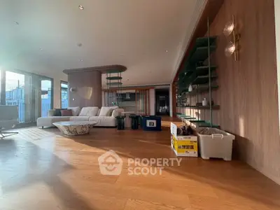 Spacious modern living room with elegant wood flooring and stylish decor