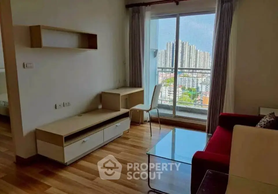 Modern living room with city view, featuring sleek furniture and large windows for natural light.