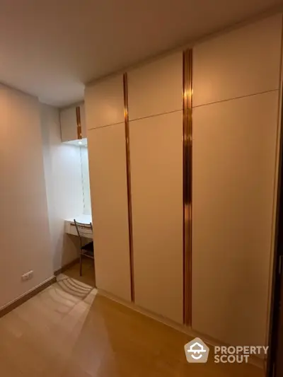 Modern bedroom with built-in wardrobe and study nook