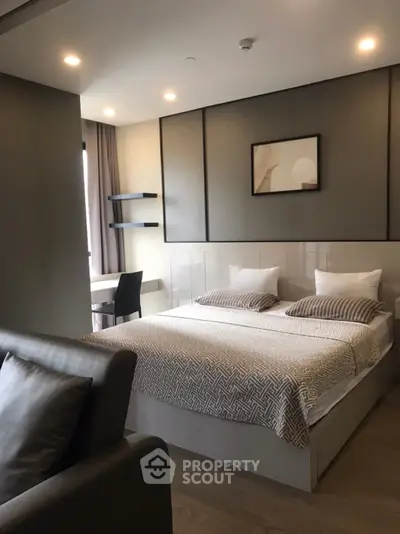 Modern bedroom with stylish decor and cozy ambiance, featuring a comfortable bed and sleek furnishings.