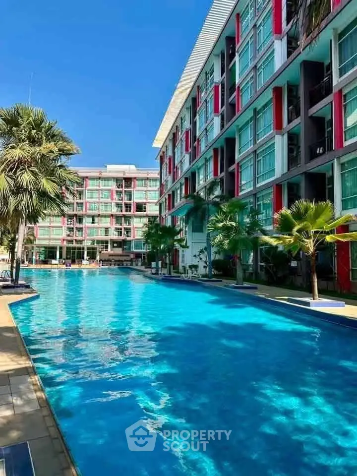 Luxurious apartment complex with a stunning outdoor pool and modern architecture.