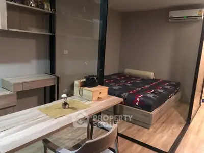 Modern studio apartment with stylish wooden furniture and cozy bed