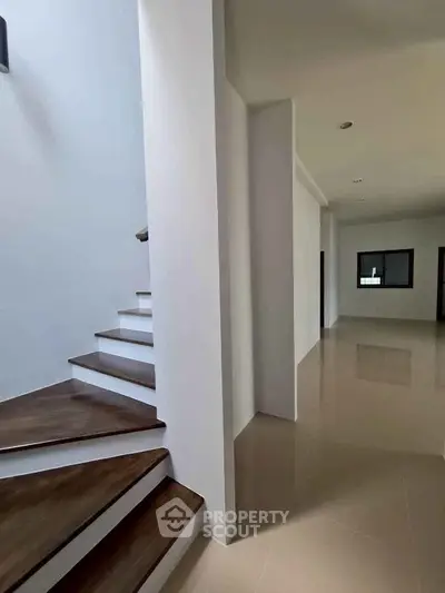 Spacious modern interior with sleek staircase and polished floors