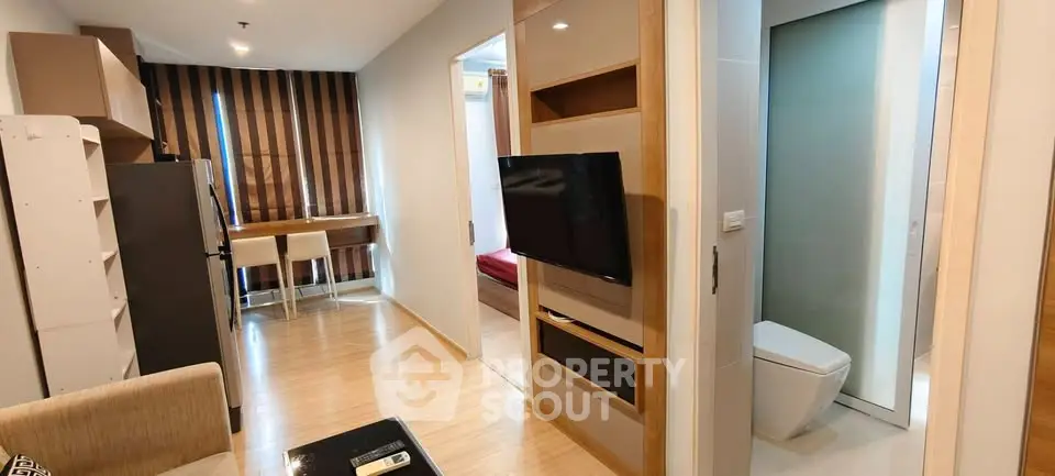 Modern apartment interior with living room, study area, and bathroom