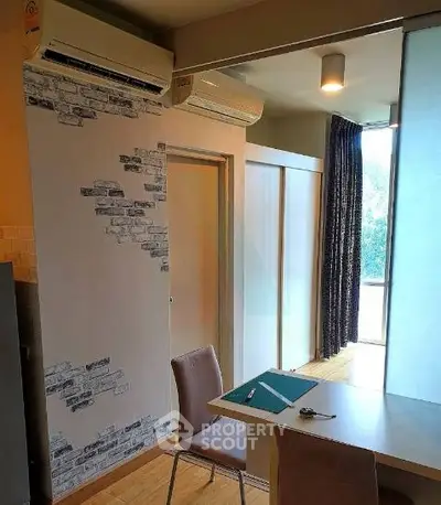 Modern apartment interior with stylish decor and air conditioning, featuring a sleek workspace and natural light.