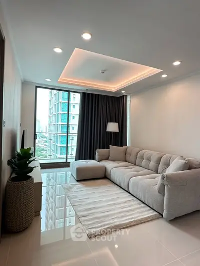 Modern living room with plush sofa and city view from large window, perfect for urban living.