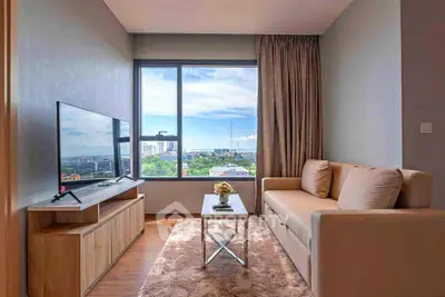 Chic living room with modern decor and stunning city view, perfect for urban living.
