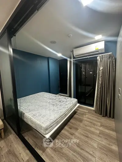 Modern bedroom with glass walls and air conditioning in a stylish apartment.
