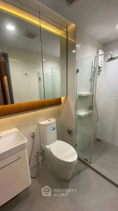 Modern bathroom with sleek fixtures and glass shower enclosure