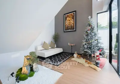 Stylish living room with festive decor and modern furniture in a bright, airy space.