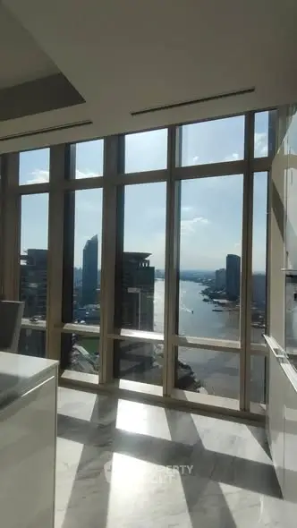 Luxurious high-rise apartment with stunning river view and floor-to-ceiling windows.